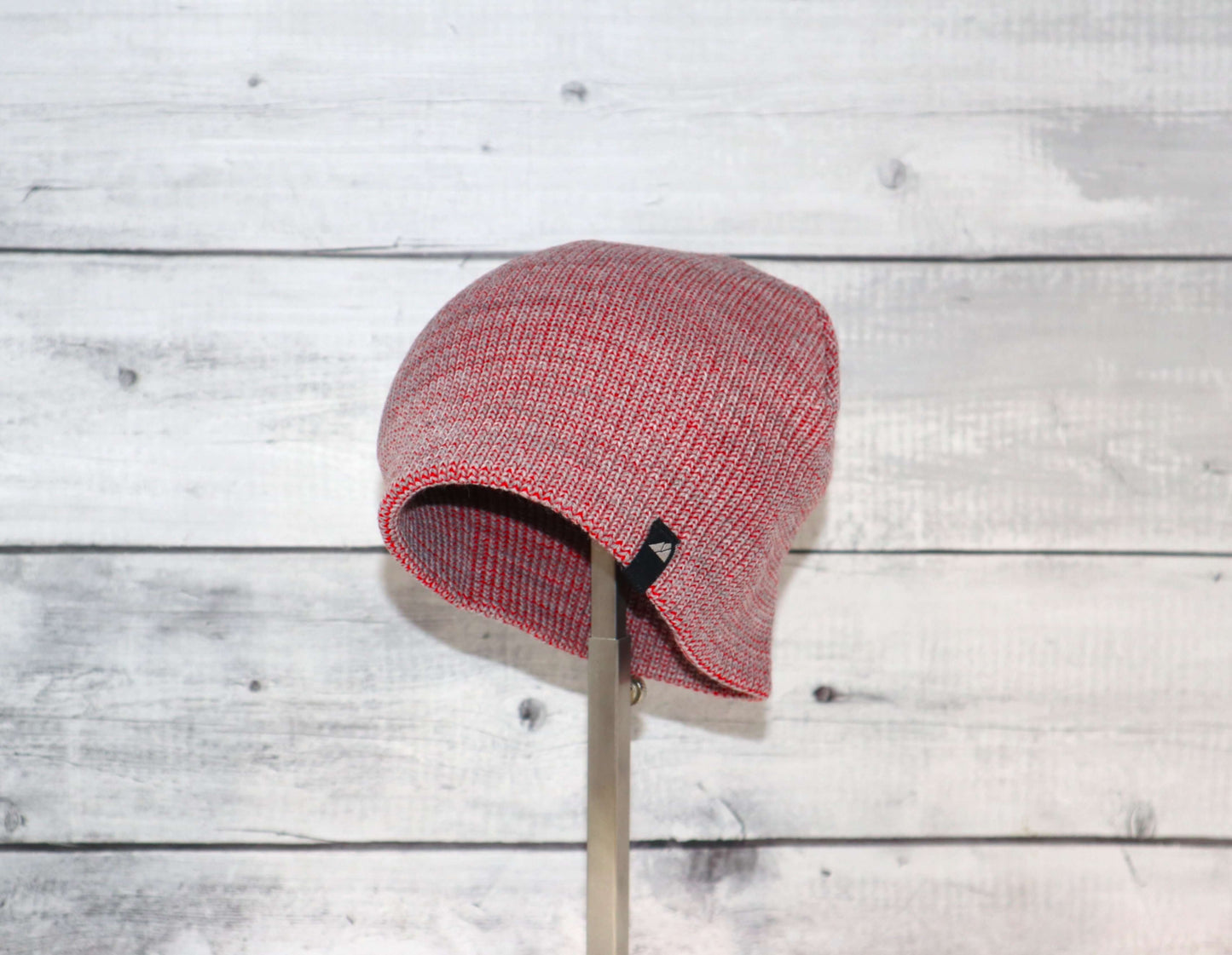 Toddler Acrylic Beanie – Soft Stretch Hat for Ages 1–3 displayed on a stand against a rustic wooden background.