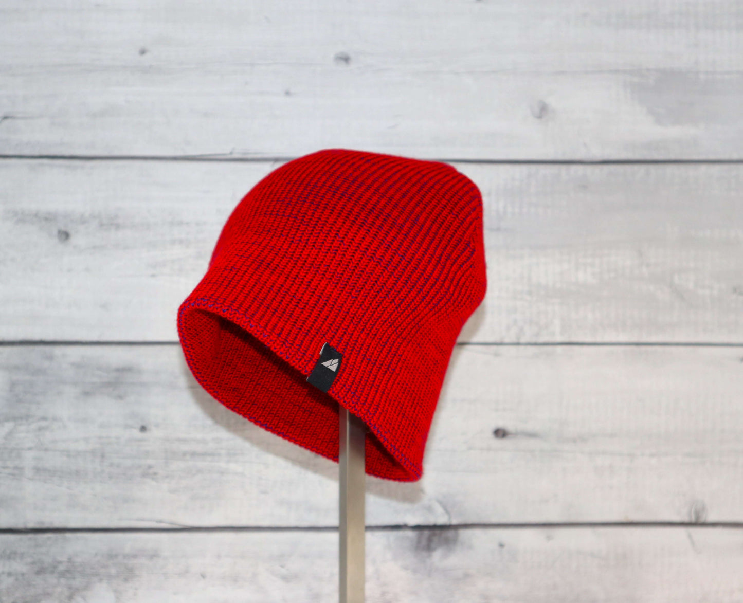 Toddler Acrylic Beanie – Soft Stretch Hat for Ages 1–3 in bright red color against a wooden background.
