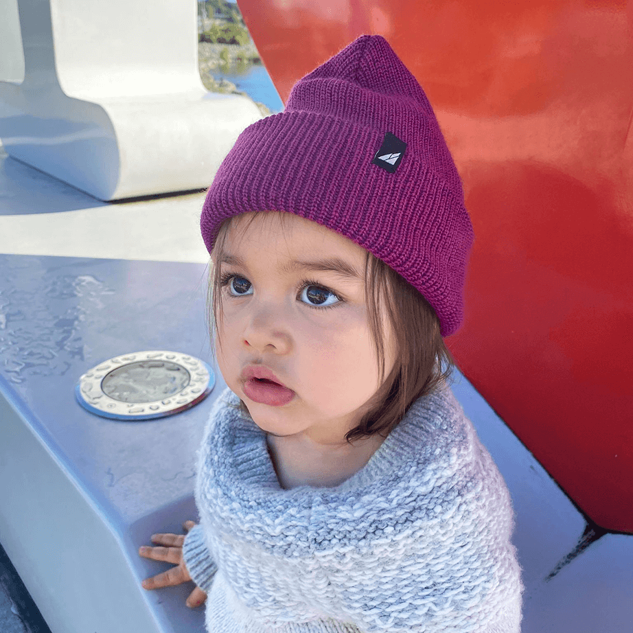 Toddler Acrylic Cuff Hat – Soft Knit Beanie worn by toddler in purple, showcasing warmth and comfort outdoors.