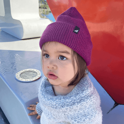 Toddler Acrylic Cuff Hat – Soft Knit Beanie worn by toddler in purple, showcasing warmth and comfort outdoors.