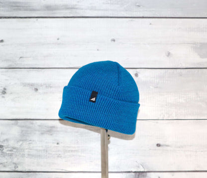 Toddler Acrylic Cuff Hat – Soft Knit Beanie in vibrant blue against a wooden background.