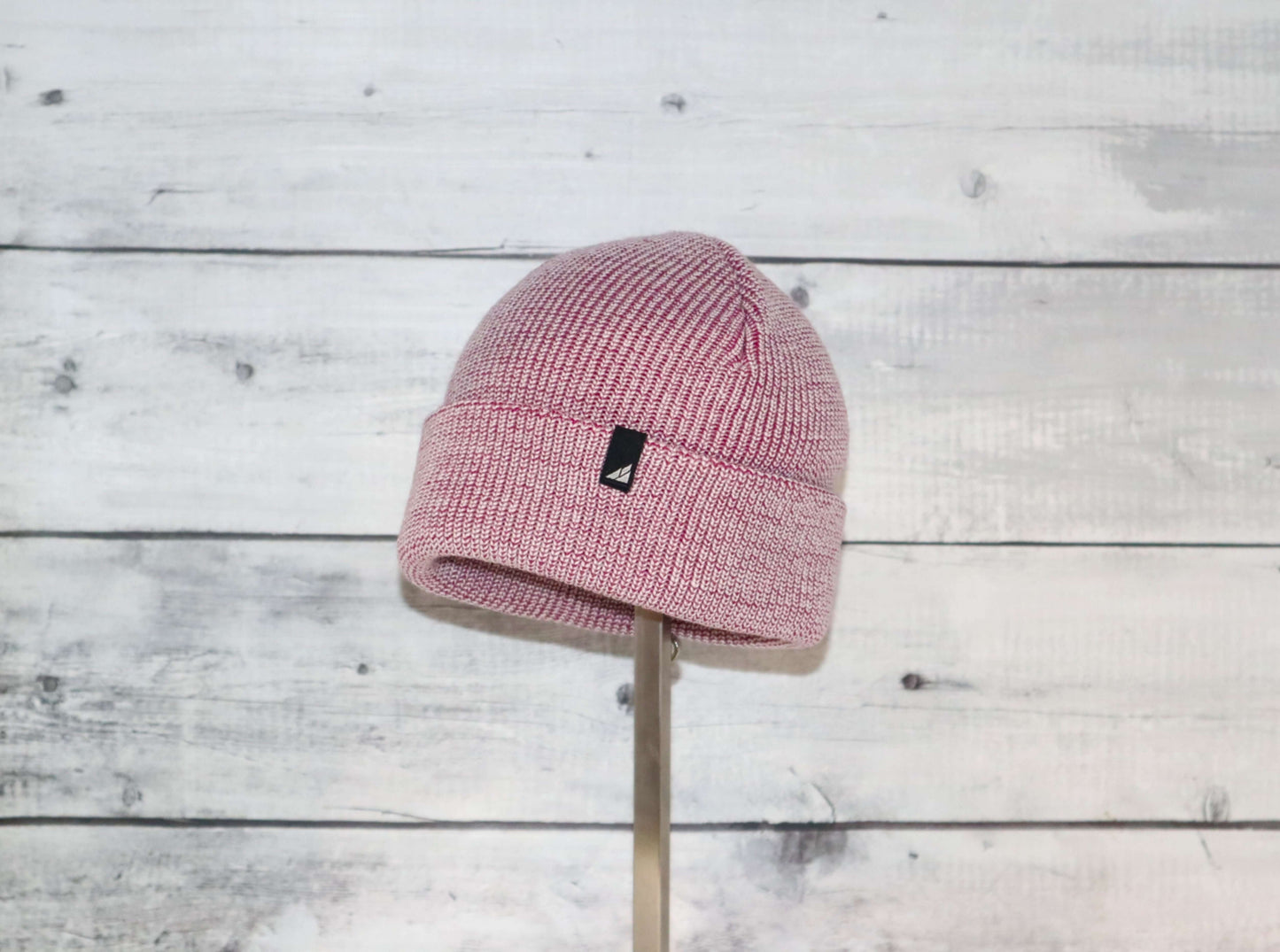 Toddler Acrylic Cuff Hat – Soft Knit Beanie displayed on a wooden stand against a rustic background.