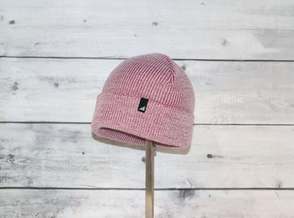 Toddler Acrylic Cuff Hat – Soft Knit Beanie displayed on a wooden stand against a rustic background.