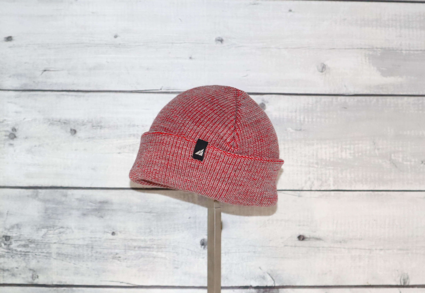 Toddler Acrylic Cuff Hat – Soft Knit Beanie in red on a wooden background.