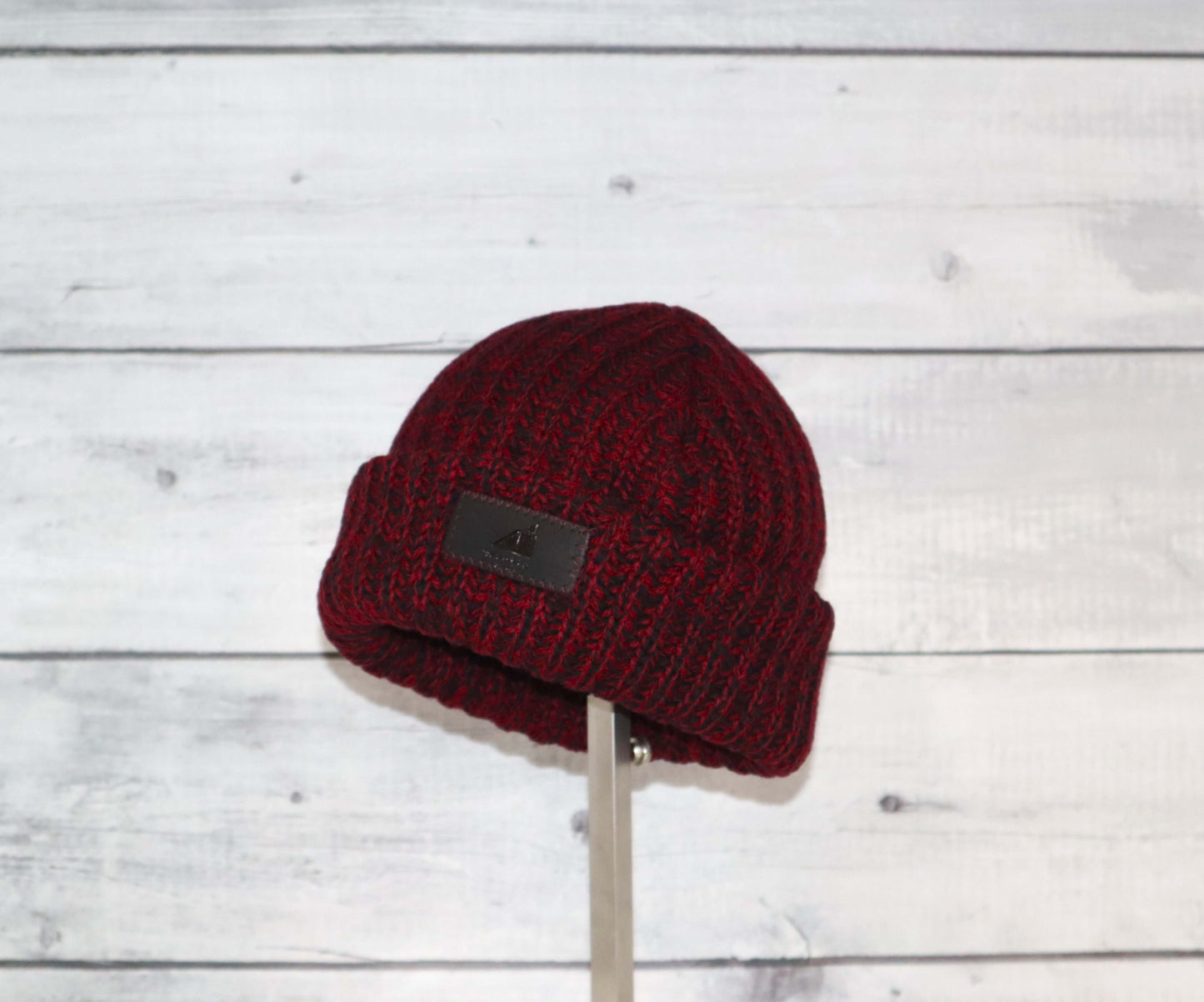 Toddler Acrylic Ribbed Cuff Hat – Soft, Stretchy & Made to Give in burgundy on a wooden background.