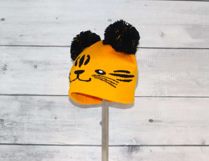 Toddler Specialty Hat – Animal-Inspired Warmth with Purpose featuring a playful tiger design with pom-poms.