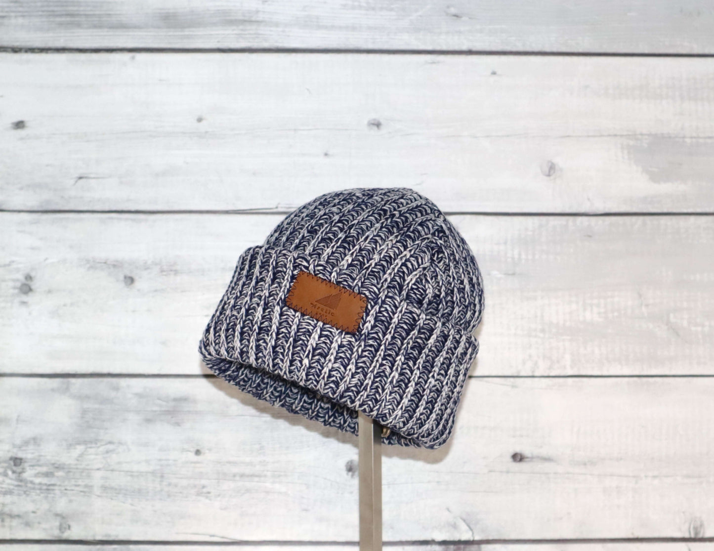Toddler Acrylic Ribbed Cuff Hat – Soft, Stretchy & Made to Give on display against a wooden background.