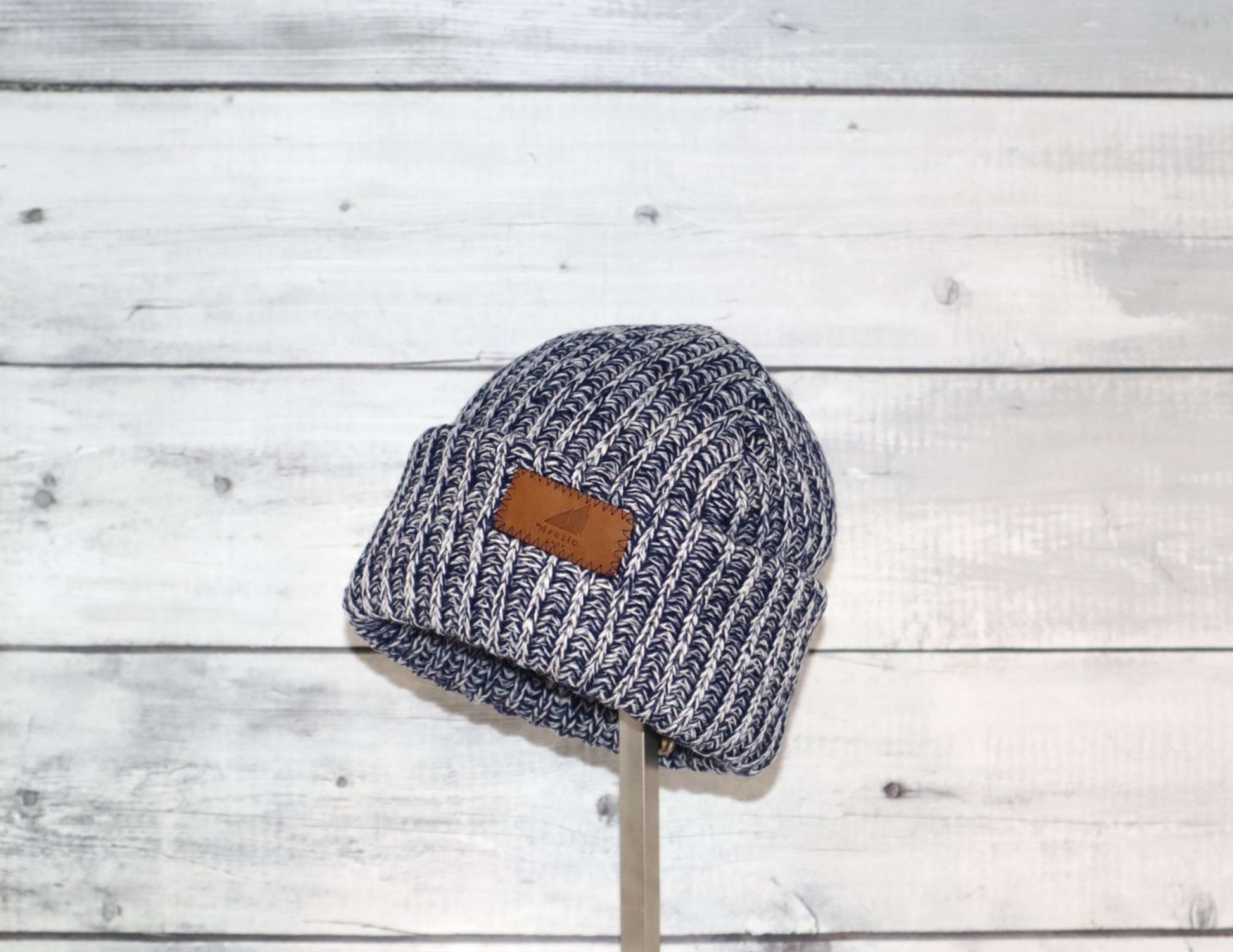 Toddler Acrylic Ribbed Cuff Hat – Soft, Stretchy & Made to Give on display against a wooden background.