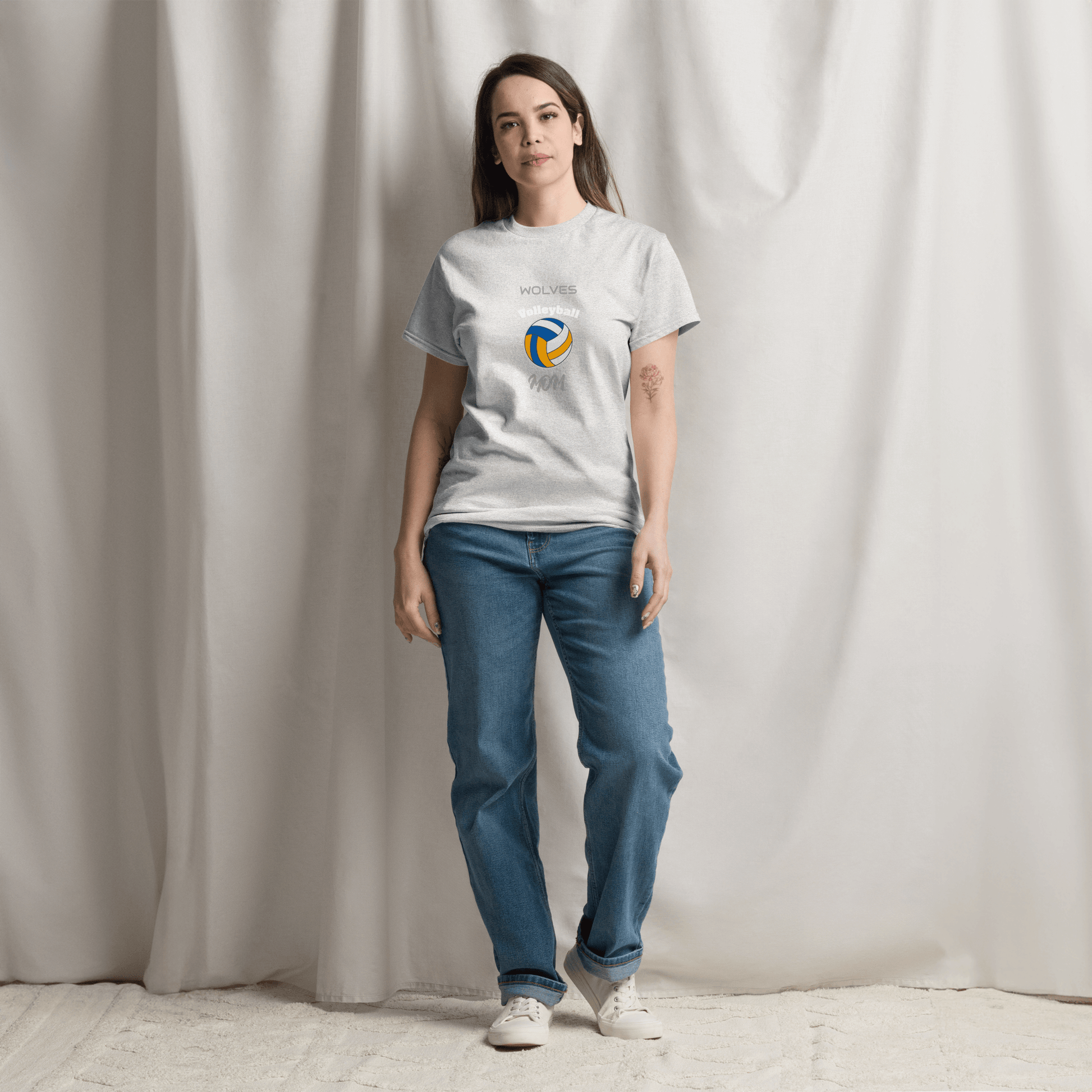 Woman wearing a gray custom volleyball parent tee featuring a colorful logo and 'WOLVES' text.