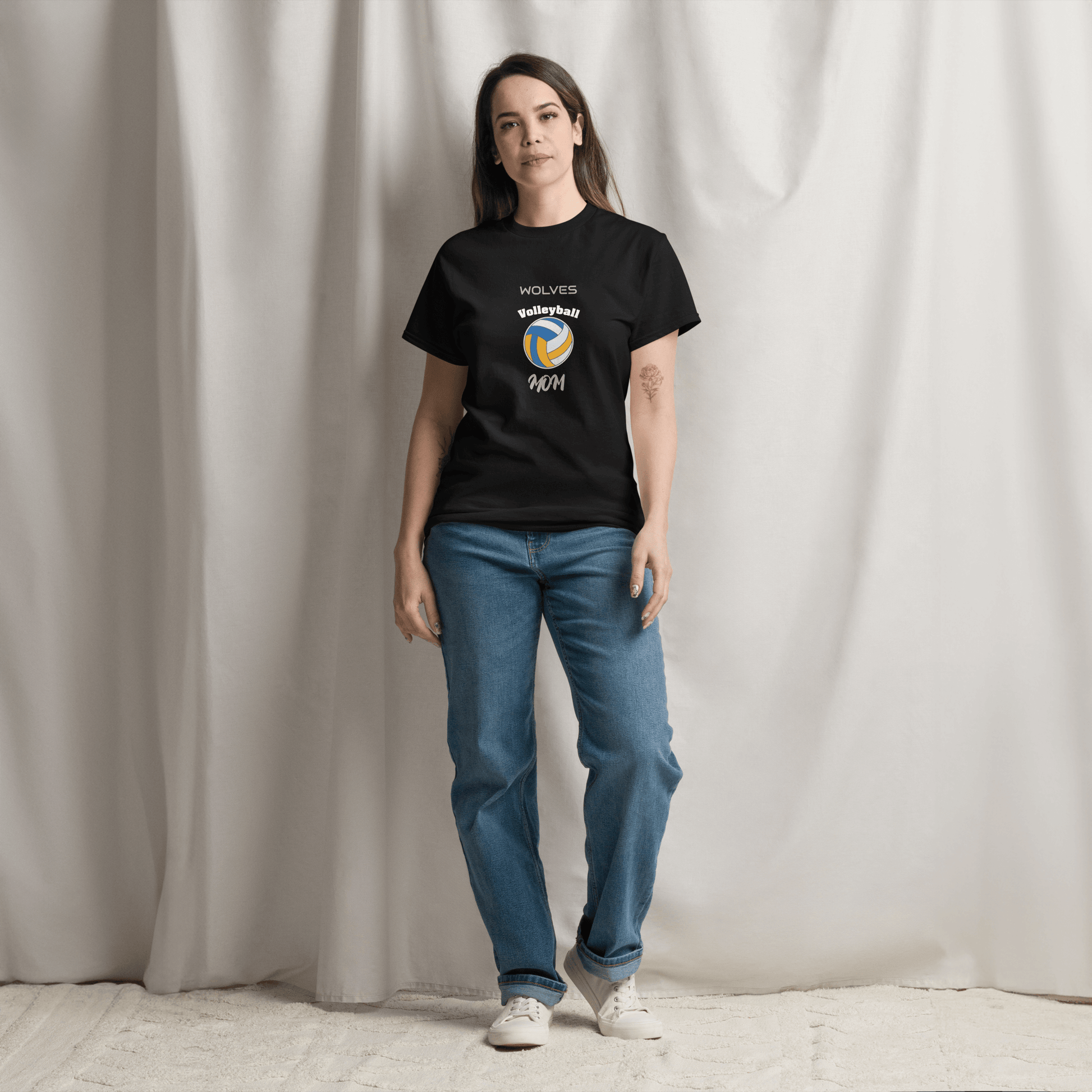 Woman wearing a black custom volleyball parent tee featuring a volleyball graphic and team name, styled for game day.