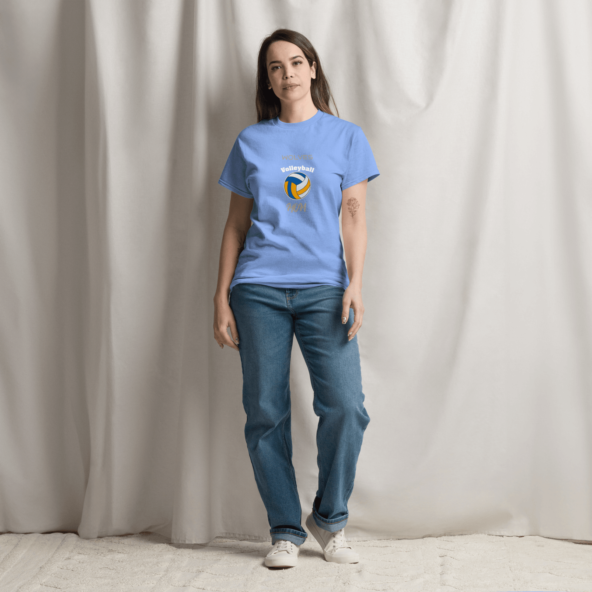 Woman wearing a custom blue volleyball parent tee, showcasing team spirit and comfort for game day.