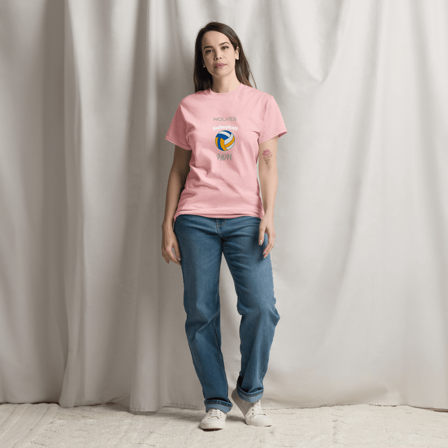 Woman wearing pink volleyball parent tee with 'Wolves' logo, showcasing game day spirit and comfort.
