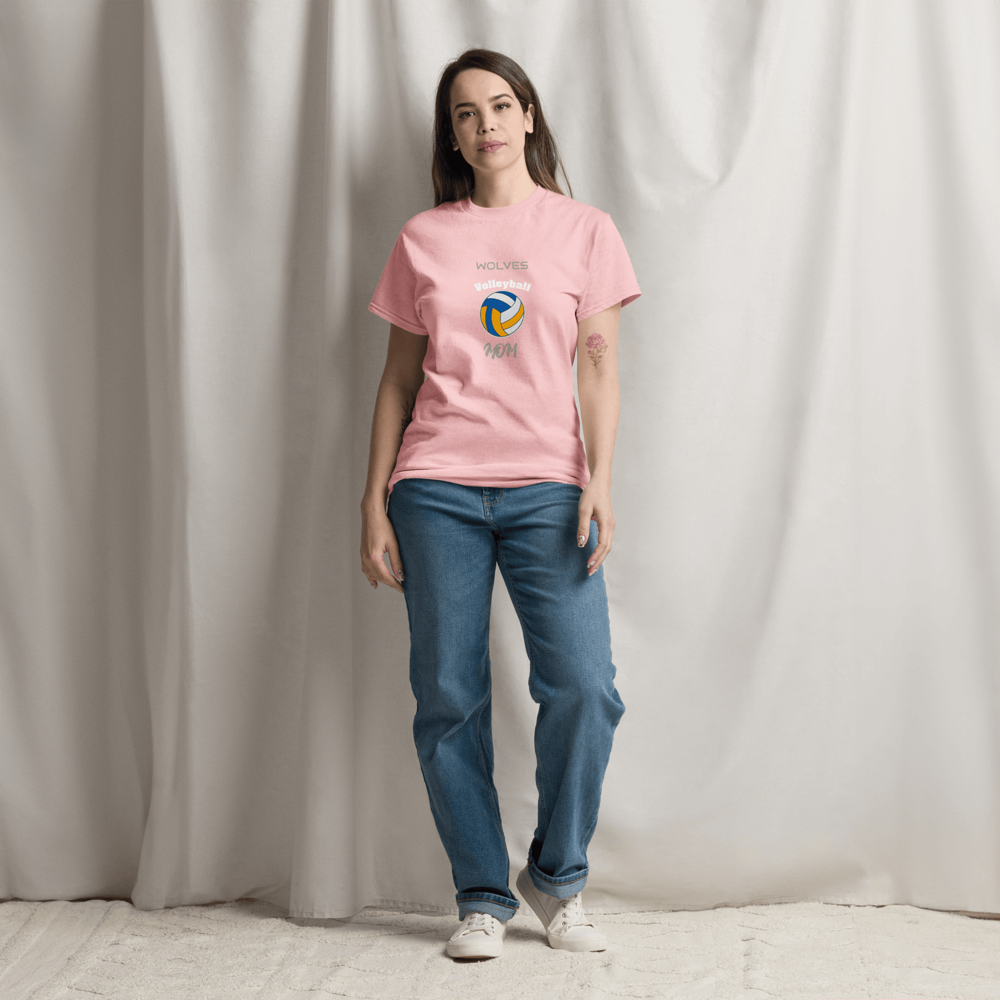 Woman wearing pink volleyball parent tee with 'Wolves' logo, showcasing game day spirit and comfort.