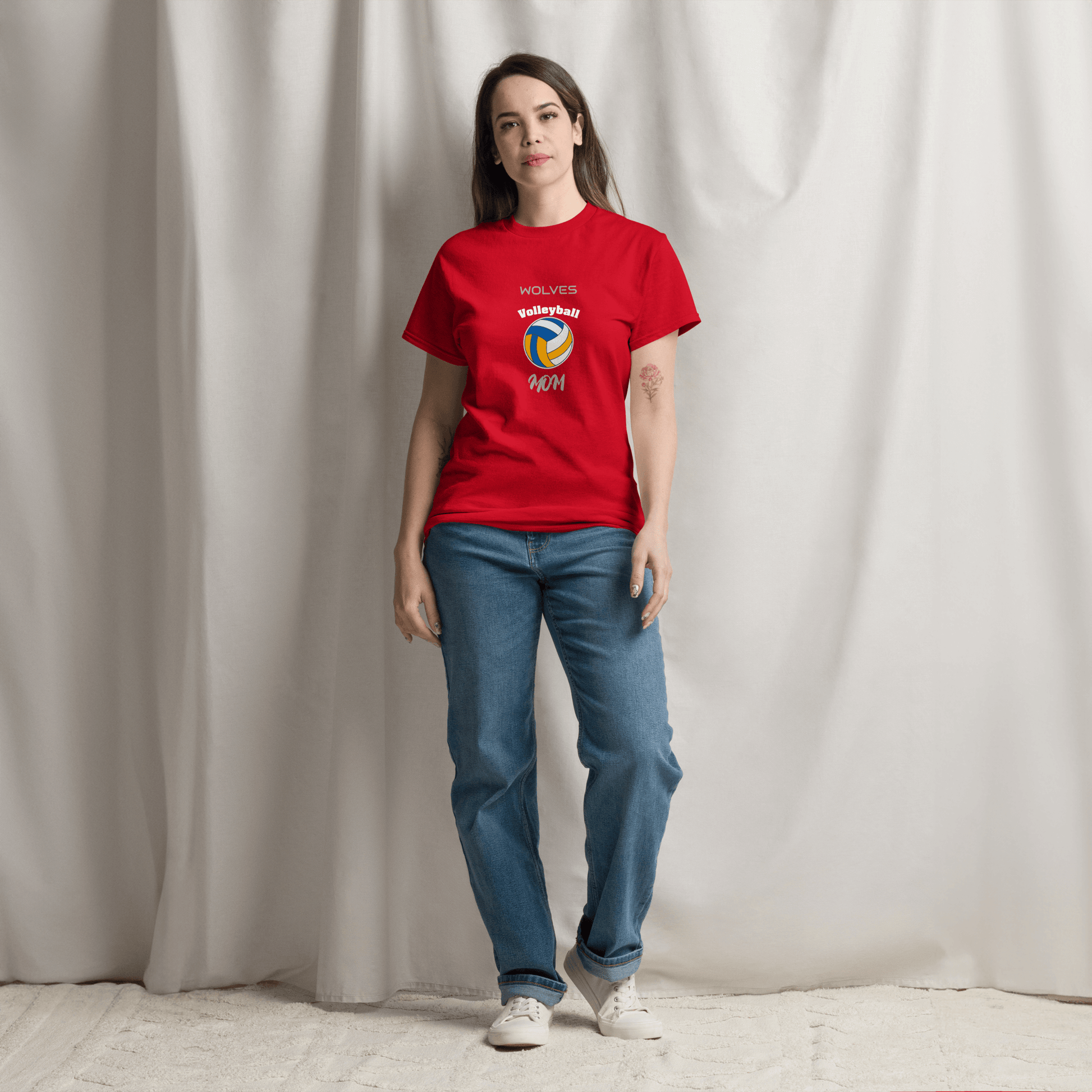 Woman wearing a red custom volleyball parent tee with Wolves logo, styled for game day support.