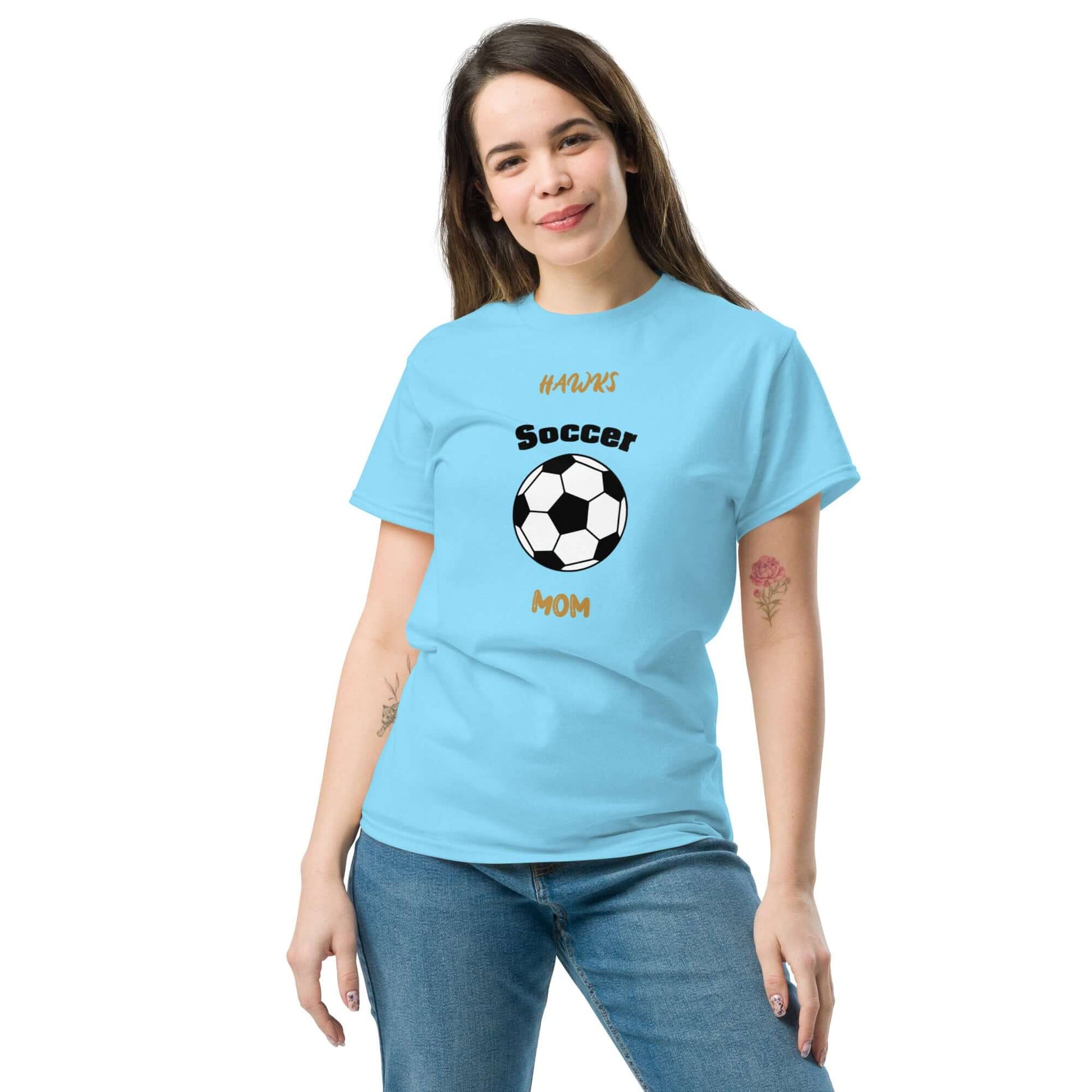 Woman wearing light blue Soccer Mom tee with black soccer ball graphic, perfect for soccer parents and fans.