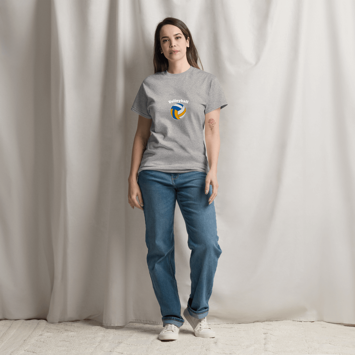 Woman wearing a gray volleyball parent tee, showcasing support for game day in casual style.