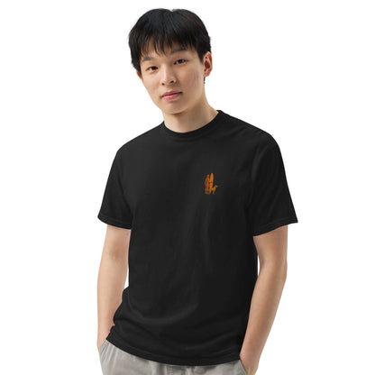Young man wearing a black Surf Sunset Heavyweight Tee with a minimalist surfer and dog design.
