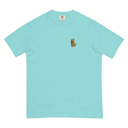 Surf Sunset Heavyweight Tee featuring a minimalist surfer and dog silhouette on a turquoise background.