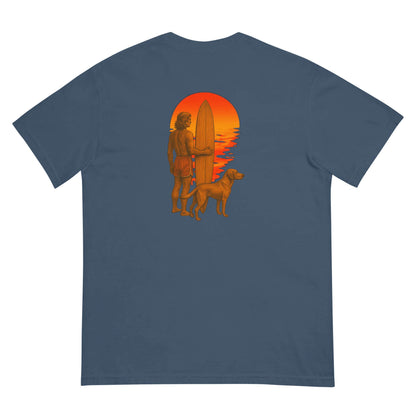Heavyweight tee featuring a silhouette of a surfer with a dog against a vibrant sunset backdrop.