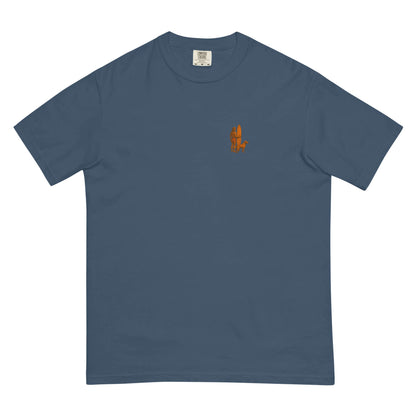 Surf Sunset heavyweight tee featuring minimalist surfer and dog logo in orange on a blue background.