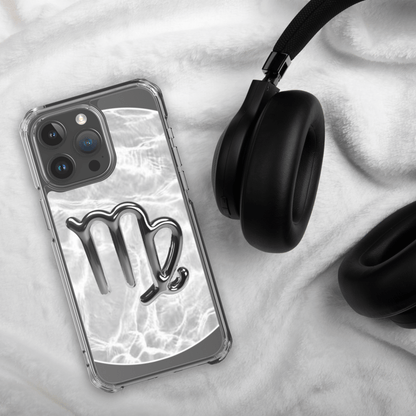 Zodiac Virgo Magsafe clear iPhone case with metallic design next to black headphones on furry surface.