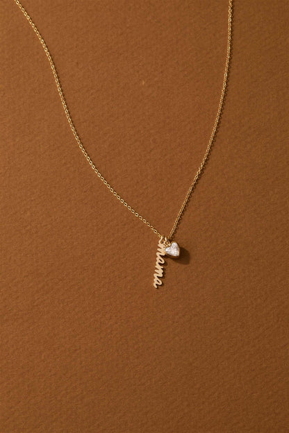 Vivienne Mama Necklace – Gold-Filled Charm & CZ Heart with a delicate charm and heart-shaped cubic zirconia on a gold chain.