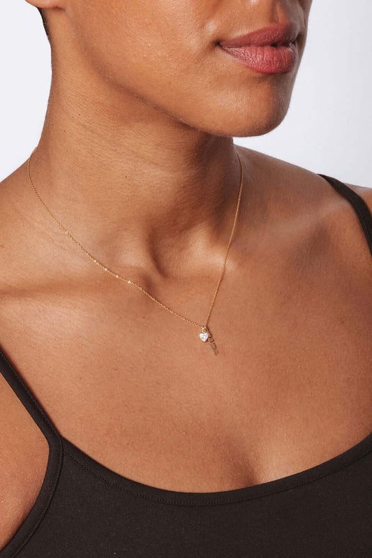 Vivienne Mama Necklace – Gold-Filled Charm & CZ Heart worn elegantly on a model's neck, showcasing its minimalist design.
