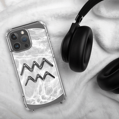 Zodiac Aquarius clear iPhone case with marble design next to black headphones on a soft fabric background.
