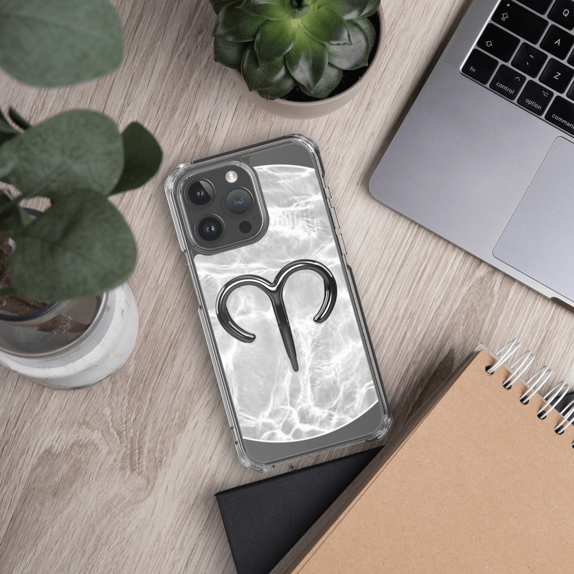 Clear MagSafe iPhone case with Aries design on marble background, showcasing cosmic style and protection.