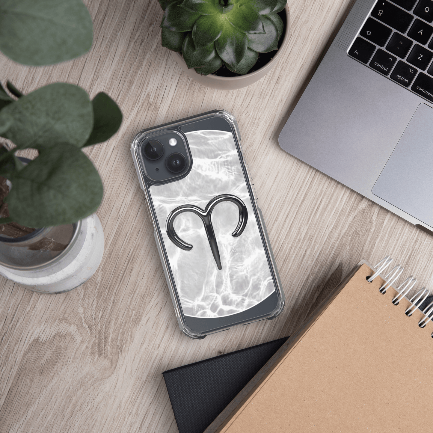 Zodiac Aries MagSafe clear iPhone case with marble design on a workspace table.