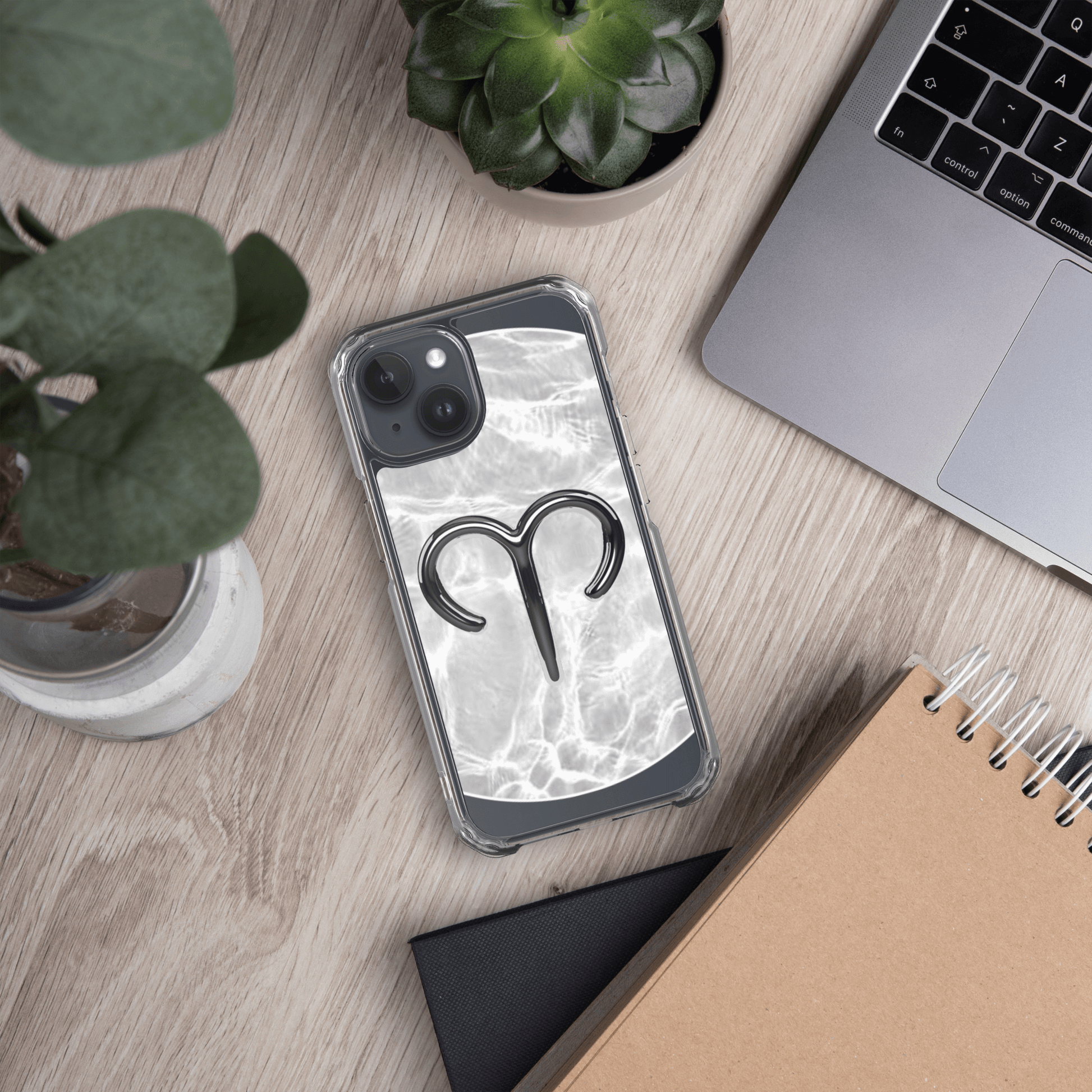 Zodiac Aries MagSafe clear iPhone case with marble design on a workspace table.