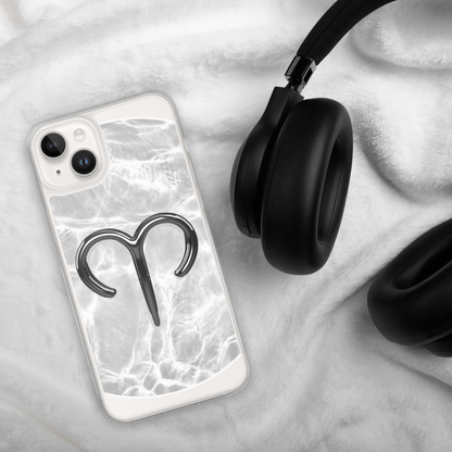 Zodiac Aries MagSafe clear iPhone case with marble design on soft surface next to black headphones.