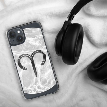Zodiac Aries MagSafe clear iPhone case with marble design and metallic symbol next to black headphones