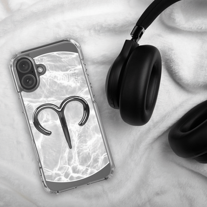 Zodiac Aries MagSafe clear iPhone case with metallic design on marble background next to black headphones.