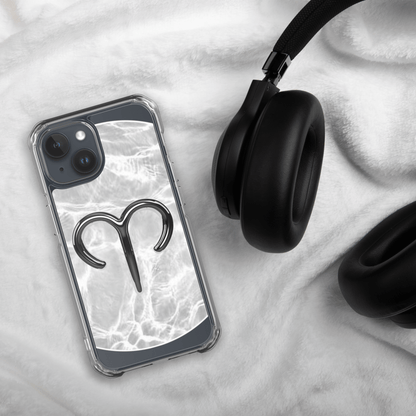 Zodiac Aries MagSafe clear iPhone case with metallic design on marble background next to black headphones.