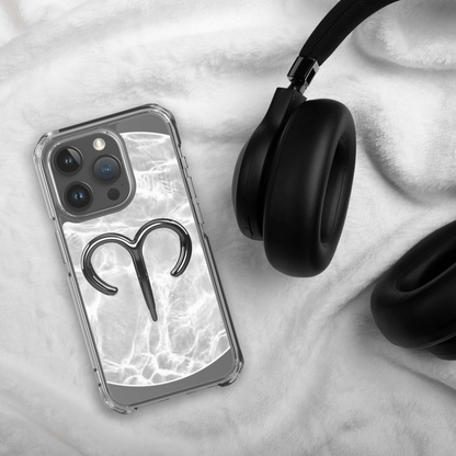Zodiac Aries MagSafe clear iPhone case on a cozy surface with headphones, showcasing a marble metallic design.