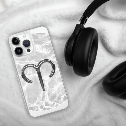 Zodiac Aries MagSafe clear iPhone case with metallic design on marble background next to headphones.