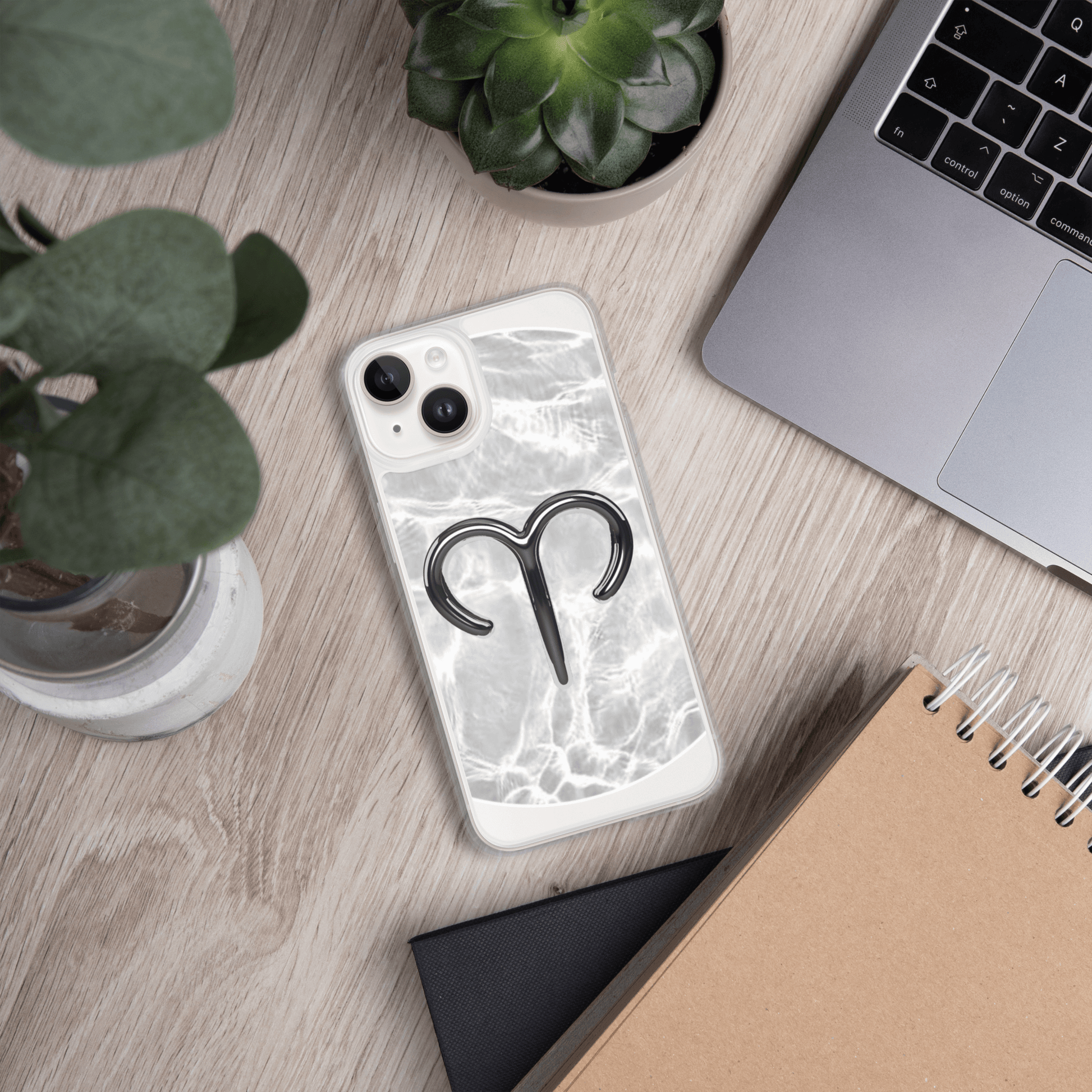 Zodiac Aries MagSafe clear iPhone case with marble design on a wooden desk.
