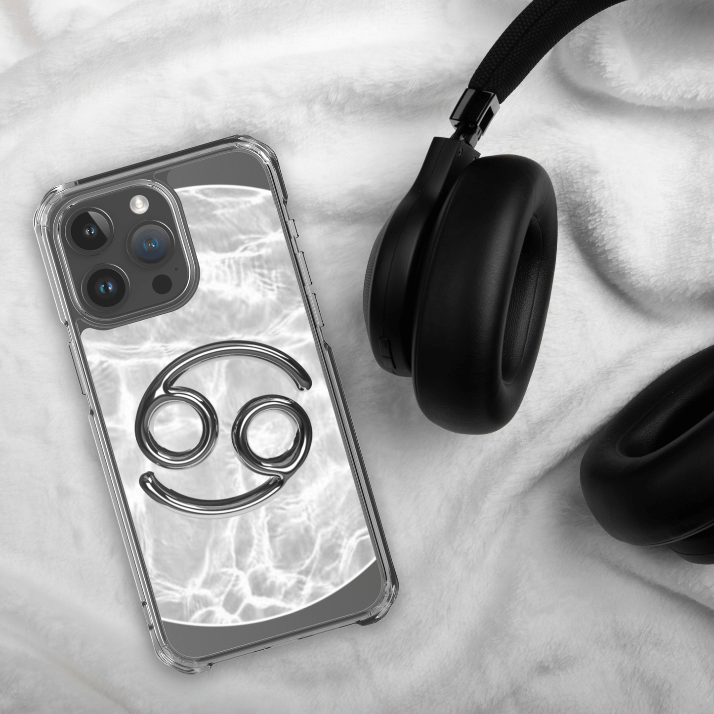 Zodiac Cancer Magsafe iPhone case with marble design, paired with black headphones on a cozy surface.