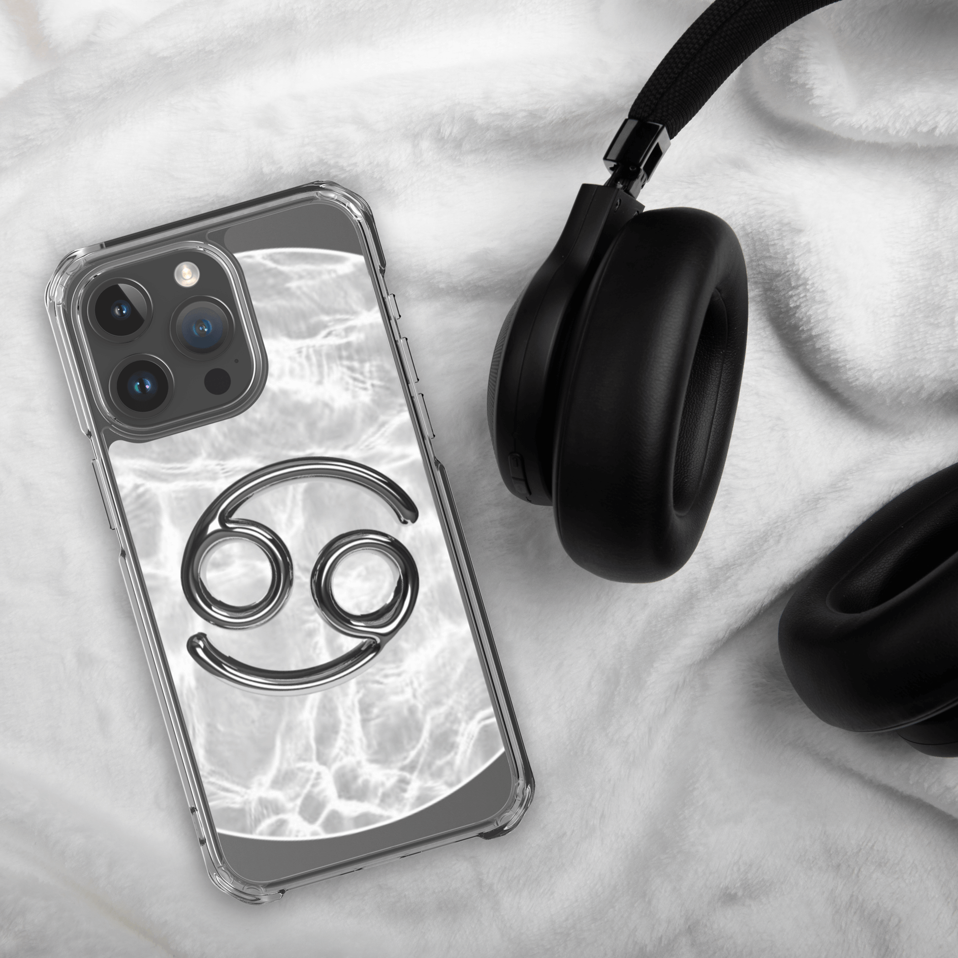 Zodiac Cancer Magsafe iPhone case with marble design, paired with black headphones on a cozy surface.