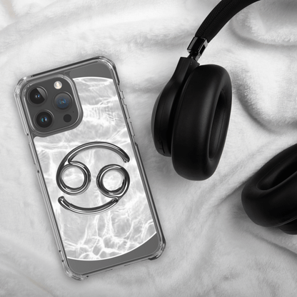 Zodiac Cancer Magsafe iPhone case with marble design, paired with black headphones on a cozy surface.