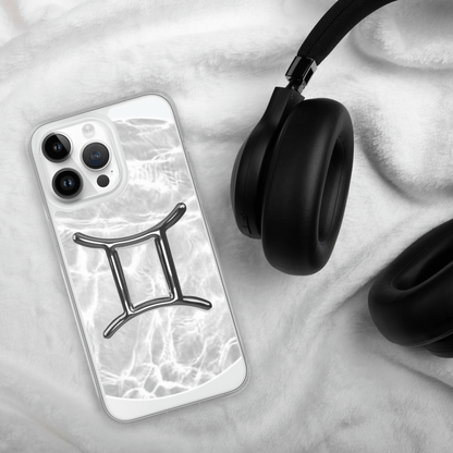 Zodiac Gemini Magsafe clear iPhone case on a white blanket with headphones, featuring a metallic design.