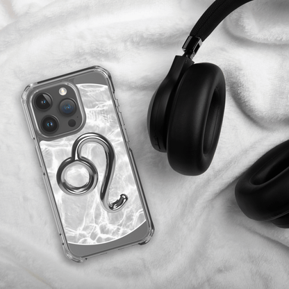 Zodiac Leo Magsafe clear iPhone case with metallic design on soft background next to black headphones.