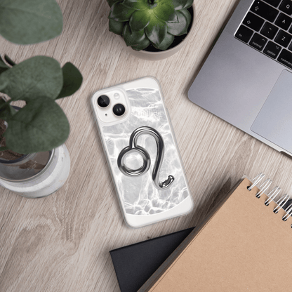 Zodiac Leo MagSafe clear iPhone case with metallic design on a marble background, surrounded by plants and a laptop.