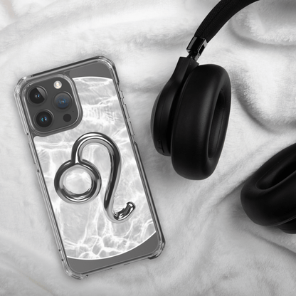 Zodiac Leo Magsafe clear iPhone case with metallic design on a cozy background next to headphones.