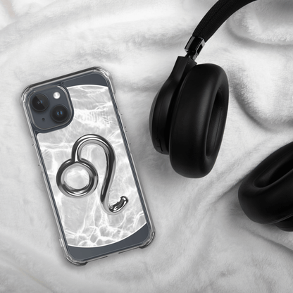 Zodiac Leo Magsafe clear iPhone case with marble design, next to black headphones on soft fabric.