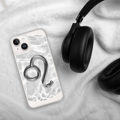 Zodiac Leo Magsafe iPhone case with metallic design on marble background next to black headphones.