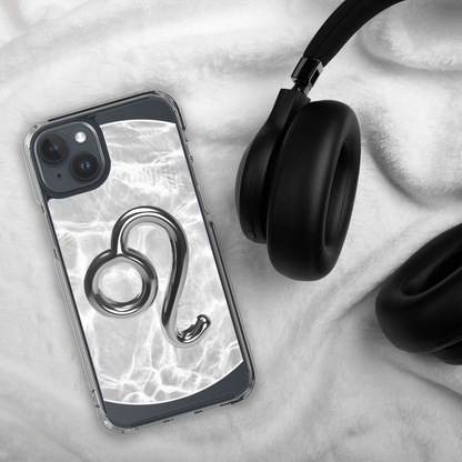 Zodiac Leo Magsafe clear iPhone case with metallic design on marble background, beside black headphones.