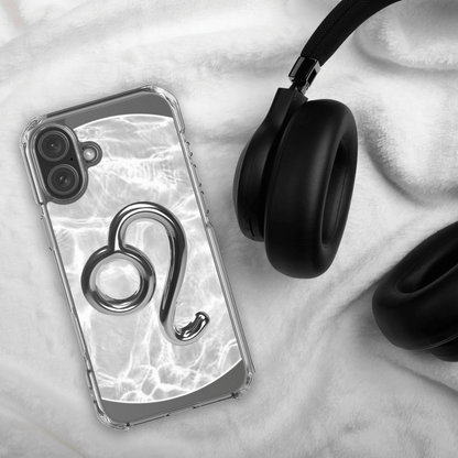 Zodiac Leo Magsafe Clear iPhone Case with metallic design on marble background next to black headphones.