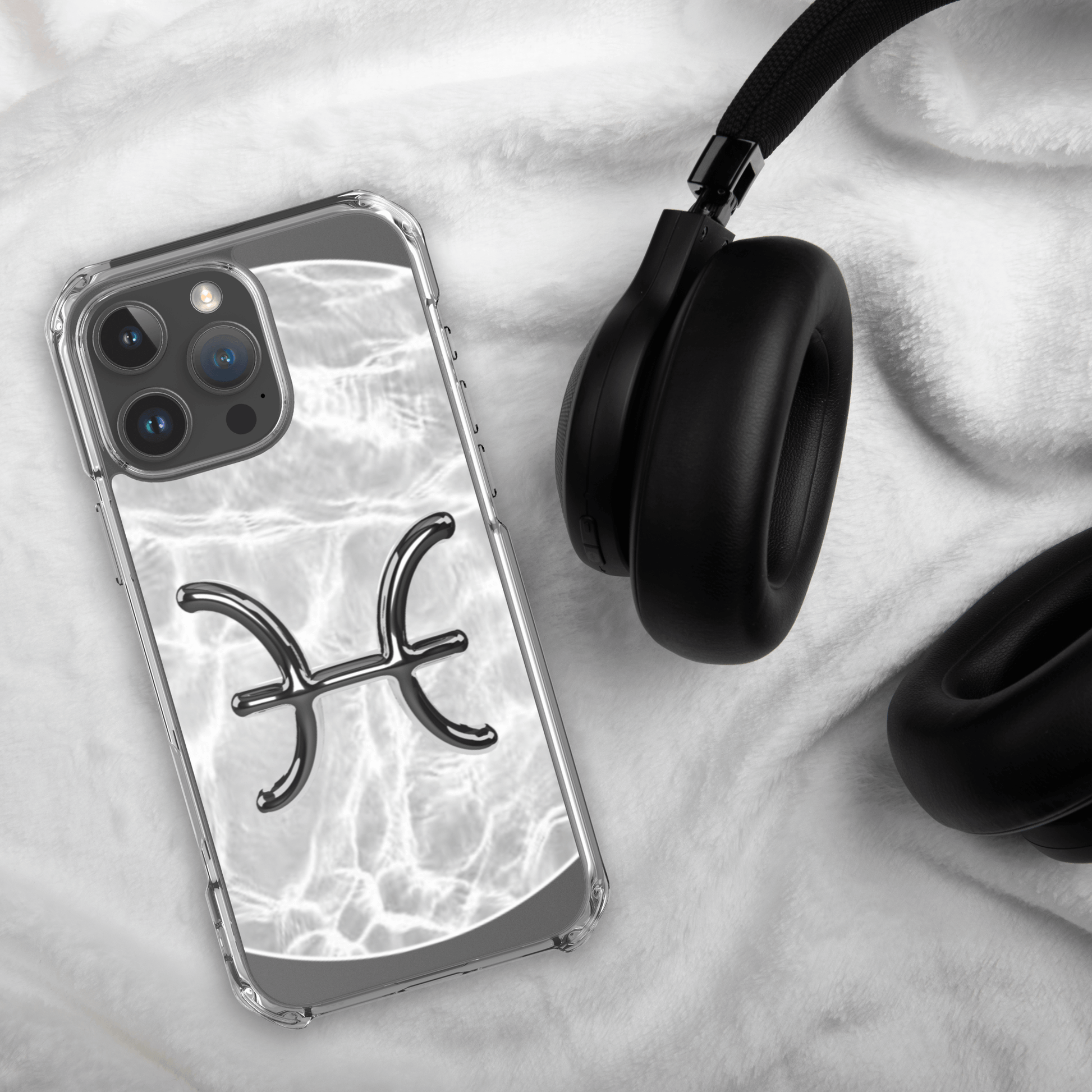 Zodiac Pisces Magsafe iPhone case with marble design on soft surface next to headphones.